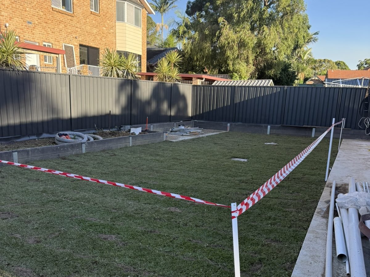 Colorbond boundary fence running the length of a residential backyard