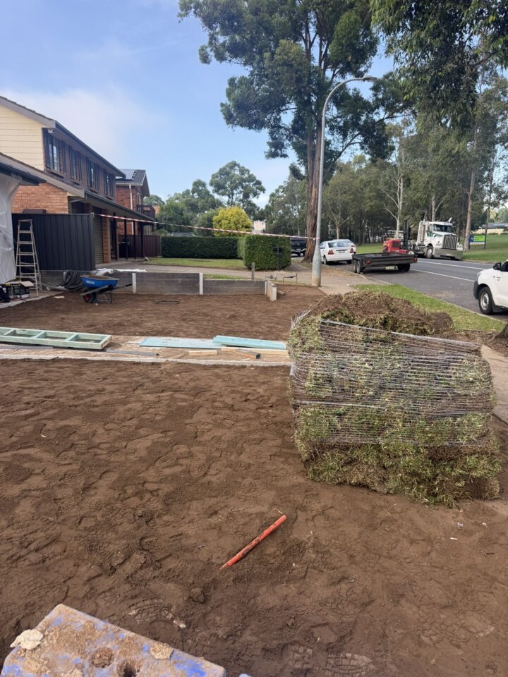 Pallets of turf ready to lay on a graded and levelled front yard